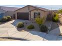 Charming single-story home with a two-car garage and well-manicured front yard at 19782 N Lauren Rd, Maricopa, AZ 85138