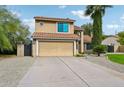 Two-story home with attached garage and attractive landscaping at 5544 E Paradise Ln, Scottsdale, AZ 85254