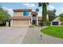Two-story home with attached garage and landscaped yard at 5544 E Paradise Ln, Scottsdale, AZ 85254