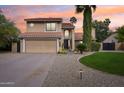 Beautiful two-story home with a large driveway and well-manicured lawn at 5544 E Paradise Ln, Scottsdale, AZ 85254