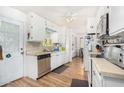 Bright kitchen with white cabinets, stainless steel appliances, and wood floors at 2650 W Union Hills Dr # 155, Phoenix, AZ 85027