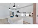 Modern white kitchen with island, stainless steel appliances, and ample counter space at 5316 E Thomas Rd, Phoenix, AZ 85018