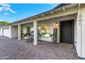 Inviting front porch with seating area and a black front door at 7730 N 2Nd Ave, Phoenix, AZ 85021