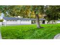 Landscaped lawn and mature trees in front of a white house at 7730 N 2Nd Ave, Phoenix, AZ 85021