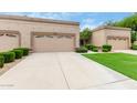 Tan stucco exterior, two-car garage, and well-manicured lawn at 8351 W Taro Ln, Peoria, AZ 85382