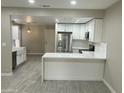 Updated kitchen, white cabinets, stainless steel appliances, and a farmhouse sink at 8351 W Taro Ln, Peoria, AZ 85382