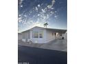 Side view of manufactured home showcasing parking and landscaping at 9427 E University Dr # 46, Mesa, AZ 85207