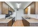 Galley-style kitchen with wood cabinets and neutral countertops at 9523 W North Ln # B, Peoria, AZ 85345