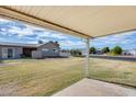 Covered patio with grassy backyard and view of neighborhood at 9523 W North Ln # B, Peoria, AZ 85345
