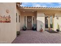 Front entry with a brick walkway, double doors, and southwestern decor at 12014 S 181St Dr, Goodyear, AZ 85338