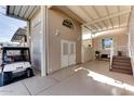 Home exterior showing covered patio area with golf cart and storage at 17200 W Bell Rd # 1218, Surprise, AZ 85374
