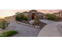 Charming one-story home with a two-car garage and landscaped front yard at 18668 W Chuckwalla Canyon Rd, Goodyear, AZ 85338