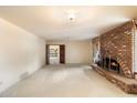 Spacious living room featuring a brick fireplace and ample natural light at 2716 E Voltaire Ave, Phoenix, AZ 85032