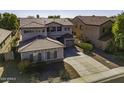 Two-story house with gray siding, a three-car garage, and a landscaped yard at 297 W Seaside Dr, Casa Grande, AZ 85122