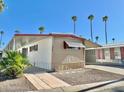Mobile home with carport, palm trees and driveway at 303 S Recker Rd # 175, Mesa, AZ 85206
