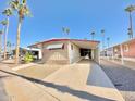 Tan mobile home with carport and palm trees at 303 S Recker Rd # 175, Mesa, AZ 85206