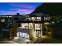 Modern home with multiple levels and city views at dusk at 5008 N Ascent Dr, Scottsdale, AZ 85251
