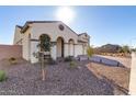 Two-story house with a three-car garage and desert landscaping at 5203 W Roundhouse Rd, Laveen, AZ 85339