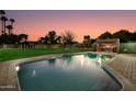 Inviting backyard oasis with a large pool and a built-in outdoor bar at 8701 E Highland Ave, Scottsdale, AZ 85251