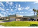 Ranch-style home with a large grassy yard and attached garage at 9913 W Pleasant Valley Rd, Sun City, AZ 85351