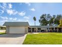 Ranch-style home with a large grassy yard and attached garage at 9913 W Pleasant Valley Rd, Sun City, AZ 85351