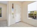 Interior entryway with neutral tile flooring and interior door at 18139 W Paradise Ln, Surprise, AZ 85388