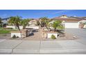 House exterior featuring a brick walkway and lush landscaping at 26702 N 97Th Ln, Peoria, AZ 85383