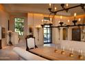 Bright dining area with a large chandelier and access to a patio at 10040 E Happy Valley Rd # 504, Scottsdale, AZ 85255