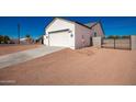 New construction home with a large driveway and a gate at 10536 E Baltimore St, Apache Junction, AZ 85120