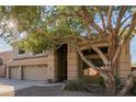 Two-story house with three-car garage and mature tree at 25714 N 70Th Ln, Peoria, AZ 85383