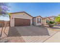 Front view of a house with brown garage door at 44033 W Palo Olmo Rd, Maricopa, AZ 85138