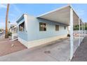 Side view of a light blue mobile home with covered parking at 535 S Alma School Rd # 12, Mesa, AZ 85210