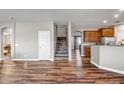 Wooden staircase with hardwood floors and neutral walls at 10439 W Cashman Dr, Peoria, AZ 85383