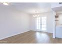 Bright dining room with hardwood floors and french doors leading to patio at 10514 W Bright Angel Cir, Sun City, AZ 85351