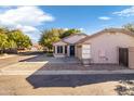 Single-story home with attached garage and a blue front door at 1628 N Serina --, Mesa, AZ 85205