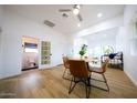 Bright dining area with a round wooden table and four brown leather chairs at 2143 W Wilshire Dr, Phoenix, AZ 85009