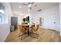 Open concept dining area with a view into the kitchen and living room at 2143 W Wilshire Dr, Phoenix, AZ 85009