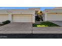 Front view of a light-colored stucco home with a two-car garage and neatly landscaped yard at 2417 E Rancho Dr, Phoenix, AZ 85016