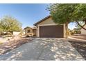 Single-story home with a two-car garage and desert landscaping at 3671 N Monument Dr, Florence, AZ 85132