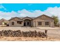 Single story house with neutral color exterior, attached garage, and stone accents at 8155 N Pueblo Cir, Casa Grande, AZ 85194