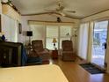 Living room with two comfy recliners and access to patio at 7750 E Broadway Rd # 149, Mesa, AZ 85208