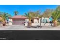 One-story home with brown garage door and desert landscaping at 2596 E Desert Wind Dr, Casa Grande, AZ 85194