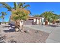One-story home with brown garage door and gravel driveway at 2596 E Desert Wind Dr, Casa Grande, AZ 85194