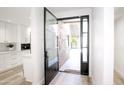 Modern entry with glass and black metal door, leading to backyard at 4446 E Camelback Rd # 111, Phoenix, AZ 85018