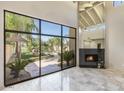 Bright living room with fireplace and view of backyard at 4710 N 65Th St, Scottsdale, AZ 85251