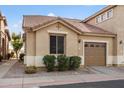 Tan stucco home with a two-car garage and nicely landscaped front at 5415 E Mckellips Rd # 37, Mesa, AZ 85215