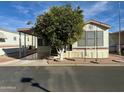 Single-wide manufactured home with covered porch and mature landscaping at 7750 E Broadway Rd # 348, Mesa, AZ 85208