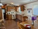 Cozy kitchen featuring wood cabinets and a full suite of appliances at 7750 E Broadway Rd # 348, Mesa, AZ 85208