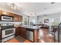 Open kitchen with stainless steel appliances and wood cabinets at 888 W Aspen Way, Gilbert, AZ 85233