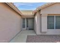 Gray front door entry to a light beige house with side windows at 1292 N Bogle Ave, Chandler, AZ 85225